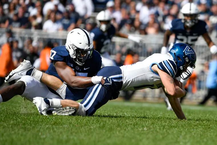 Penn State defensive end Arnold Ebiketie (17) sacks Villanova quarterback Daniel Smith, right, during an NCAA college football game in State College, Pa., on Saturday, Sept. 25, 2021.