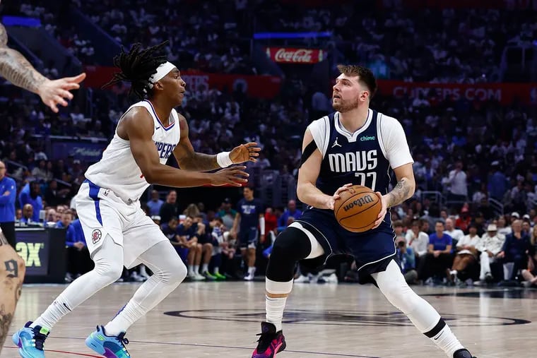 Luka Doncic #77 of the Dallas Mavericks and Terance Mann #14 of the LA Clippers during game five of the Western Conference First Round Playoffs at Crypto.com Arena on May 01, 2024 in Los Angeles, California. (Photo by Ronald Martinez/Getty Images)