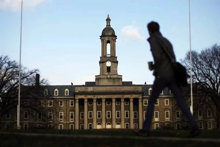 A students walks by the Old Main building on the Penn State campus Friday, Nov. 11, 2011, in State College, Pa.    ( (AP Photo/Matt Rourke)