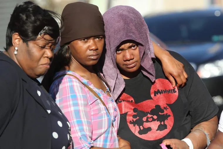 Tara Riddick, right, the mother of the 4 year old girl that was allegedly shot by her father in Kensington, is comforted by family and friends during a prayer vigil in front of the family’s home on Monday, April 18, 2016.