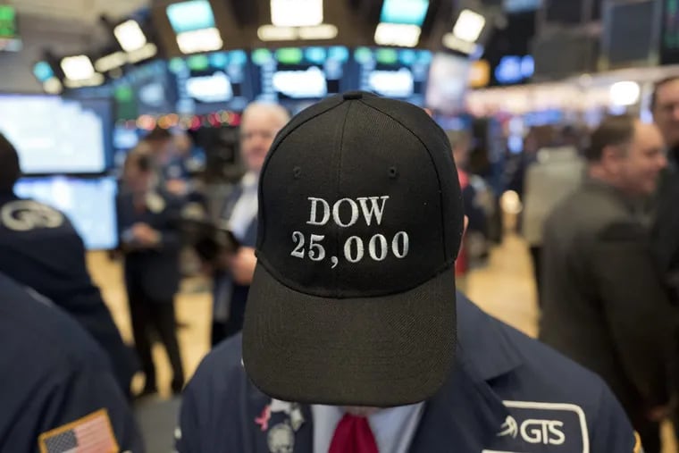 A stock trader wears a Dow 25,000 hat, Thursday, Jan. 4, 2018, at the New York Stock Exchange. The Dow Jones industrial average closed above 25,000 points for the first time, just five weeks after its first close above 24,000. (AP Photo/Mark Lennihan)