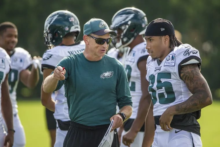 Eagles safeties coach Tim Hauck talks with the Eagles new cornerback Ronald Darby (35) on Sunday.