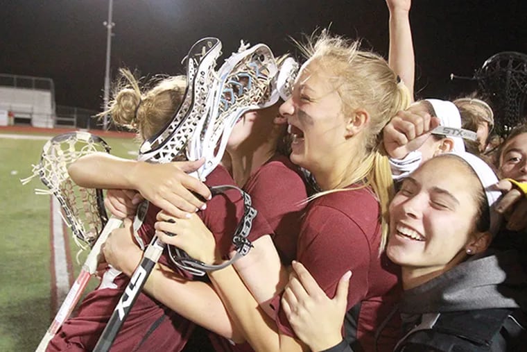 Conestoga players celebrate after scoring seven unanswered goals to defeat Garnet Valley in girls lacrosse on April 28, 2015. (Charles Fox / Staff Photographer)