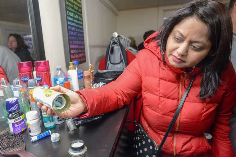 Rashmi Sharma, of Warrington, looks at an air freshener can that also serves as a hiding place for drugs in the mock bedroom designed to show parents how to spot signs of drugs and other behaviors as well as a Narcan workshop Monday, February 25, 2019 at Central Bucks South High School in Warrington, Pennsylvania.