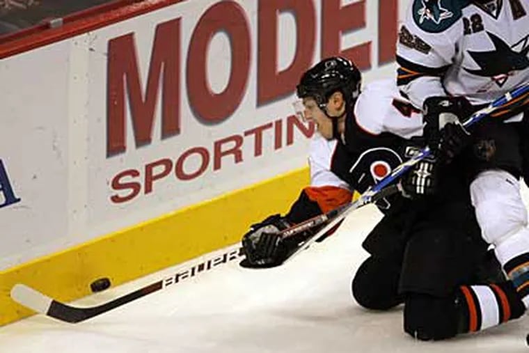 Flyers' Danny Briere goes after the puck against San Jose Sharks' Dan Boyle during the third period. (Yong Kim / Staff Photographer)