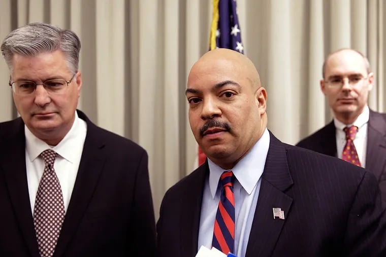 Philadelphia District Attorney Seth Williams accompanied by investigators Marc Costanzo, left, and Frank Fina, walks away after a news conference Monday, Jan. 27, 2014, in Philadelphia.  (AP Photo/Matt Rourke)