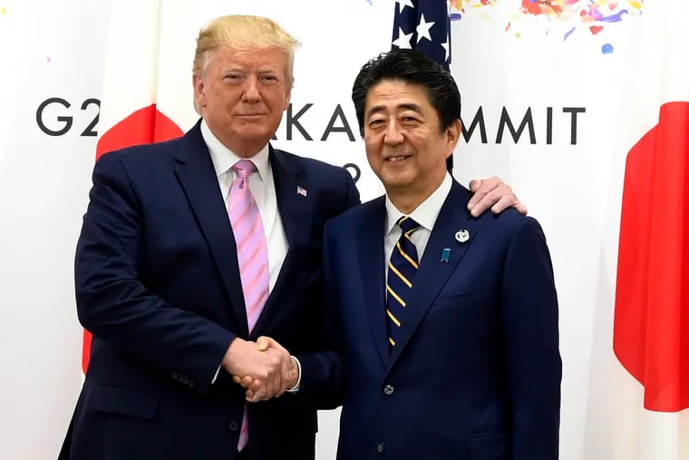 President Donald Trump shakes hands with Japanese Prime Minister Shinzo Abe during a meeting on the sidelines of the G-20 summit in Osaka, Japan, Friday, June 28, 2019.