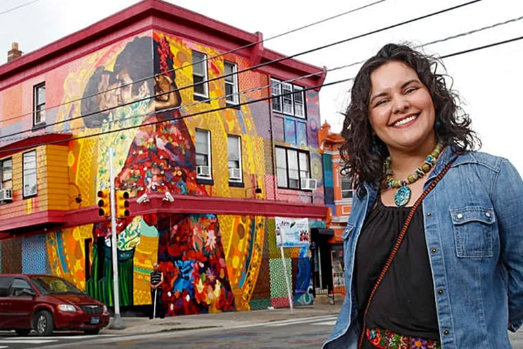 Betsy Casa&#0241;as stands in front of her mural &quot;Aqui Se Respira Lucha (Here We Breathe Struggle)&quot; on Front Street between Allegheny and Westmoreland. (MICHAEL BRYANT / Staff Photographer)