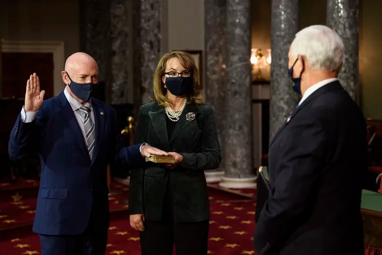 U.S. Democtatic Senator from Arizona Mark Kelly is sworn in by Vice President Mike Pence as Kelly's wife, former U.S. Representative from Arizona Gabby Giffords, looks on at the U.S. Capitol.