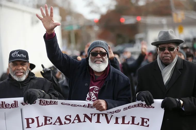From left, Pleasantville Public Schools board member Jerome Page, high school principal Howard Johnson, and Atlantic City Councilman Kaleem Shabazz participate in a community march against violence in Pleasantville on Saturday. The march was organized after 10-year-old Micah Tennant was shot by a gunman apparently targeting another man during a Pleasantville football game Nov. 15; Micah died Wednesday.