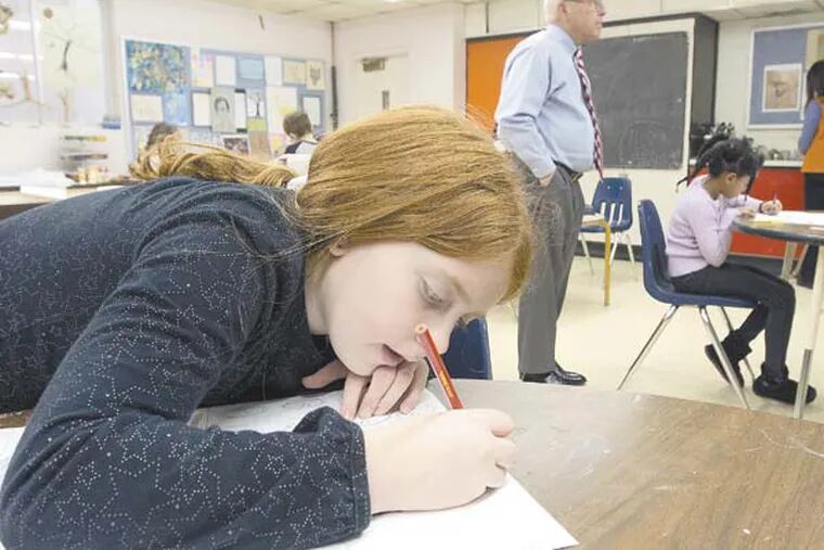 Second grader Julianna Banfe, 9, draws in art class.  In background is Headmaster William C. Probsting at Westfield Friends School, Cinnaminson, February 5, 2013.  ( DAVID M WARREN / Staff Photographer )