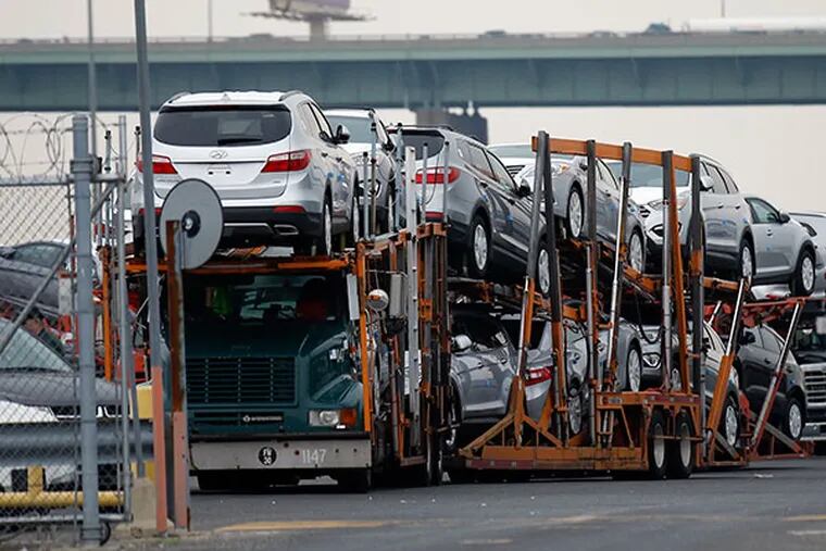 Hyundai automobiles sit on a transporter in a lot in South Philadelphia on Thursday, May 22, 2014.  ( Yong Kim / Staff Photographer )
