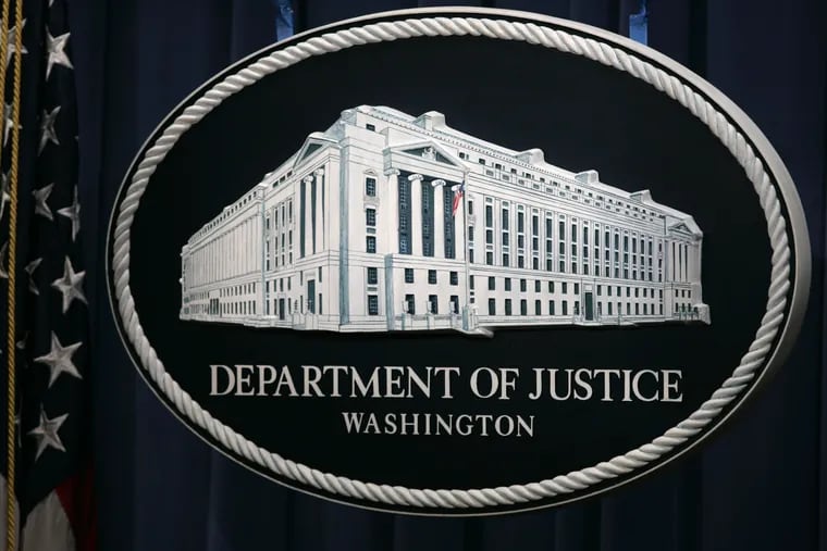 The sign that serves as the backdrop for press briefings at the Department of Justice is seen before a press conference Wednesday, Aug. 9, 2006 in Washington.