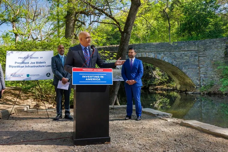Federal highway officials, including Shailen Bhatt, the administrator of the Federal Highway Administration, announced $14.2 million grant to refurbish two bridges over the Wissahickon Creek.