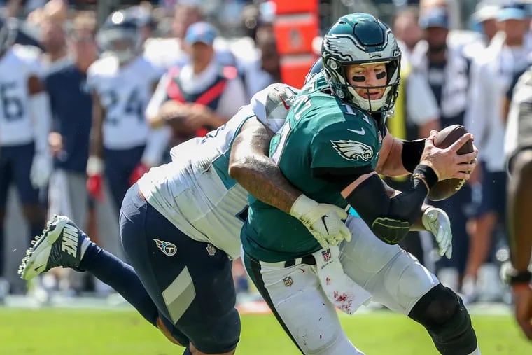 Carson Wentz tries to shake off Titans defensive tackle Jurrell Casey in the second quarter.