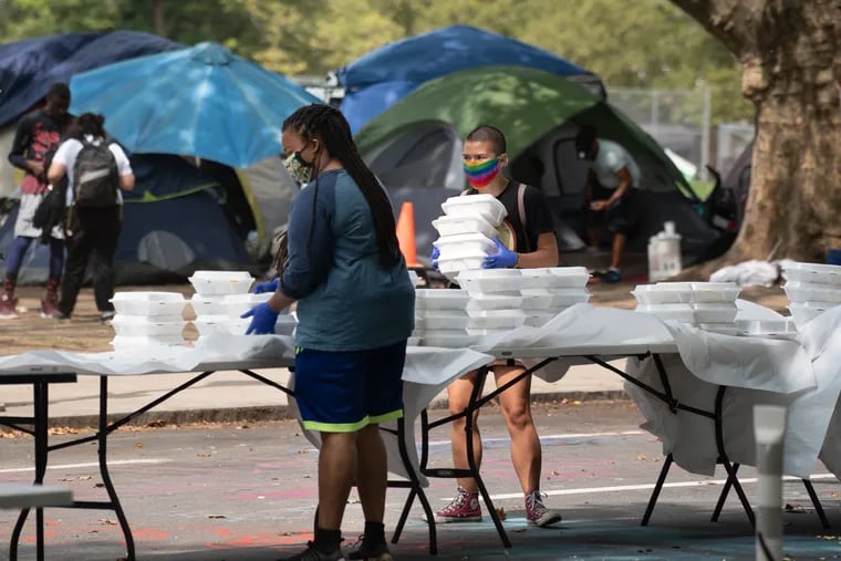 People at the Parkway encampment distribute catered brunch meals at 22nd St. during a brunch that they invited Mayor Jim Kenney to, in Philadelphia, September 14, 2020.