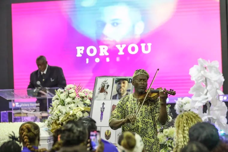Owen Brown performs during the funeral service for Joseph Wamah Jr. at Victory Harvest Fellowship International in Southwest Philadelphia on Saturday. Wamah was the first of the victims in the Kingsessing mass shooting last month.