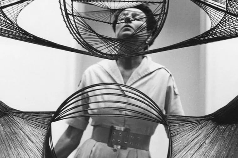 Peggy Guggenheim seen through a sculpture, from "Peggy Guggenheim - Art Addict."