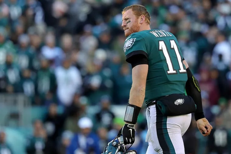 Eagles Carson Wentz walks off the field after fumbling away the football against the Panthers in the 4th quarter. Philadelphia Eagles lose 21-17 to the Carolina Panthers in Philadelphia, PA on October 21, 2018. DAVID MAIALETTI / Staff Photographer