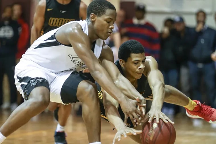 Bishop McDevitt's Robert Smith, left tries for the loose ball with Archbishop Wood's Muneer Newton during the 4th quarter of Catholic League Quarter Finals in Glenside. Pa., Friday, February 15, 2019. McDevitt beats Wood 52-49.