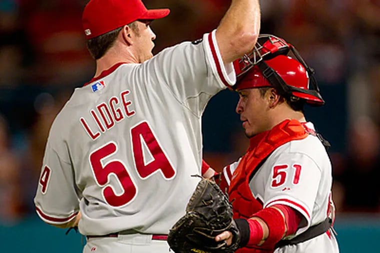 Brad Lidge and Carlos Ruiz celebrate after finishing off the 10th inning against the Marlins. (AP Photo/J Pat Carter)