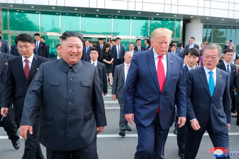In this Sunday, June 30, 2019, photo provided by the North Korean government, North Korean leader Kim Jong Un, front left, U.S. President Donald Trump, front center, and South Korean President Moon Jae-in, front right, walk together at the border village of Panmunjom in Demilitarized Zone. The content of this image is as provided and cannot be independently verified. Korean language watermark on image as provided by source reads: "KCNA" which is the abbreviation for Korean Central News Agency. (Korean Central News Agency/Korea News Service via AP)