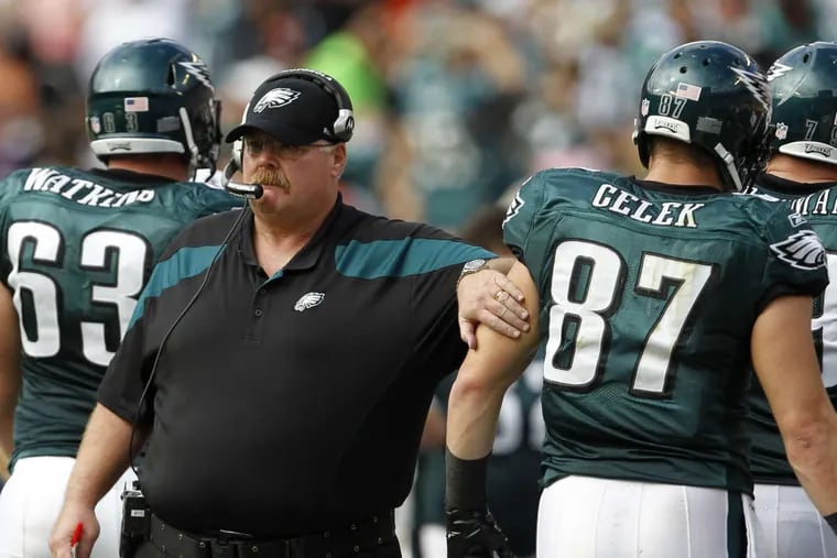 Eagles coach Andy Reid (left) pats tight end Brent Celek during a Dec. 11, 2011, game in Miami. Reid will coach for the Chiefs against his former team on Sunday.