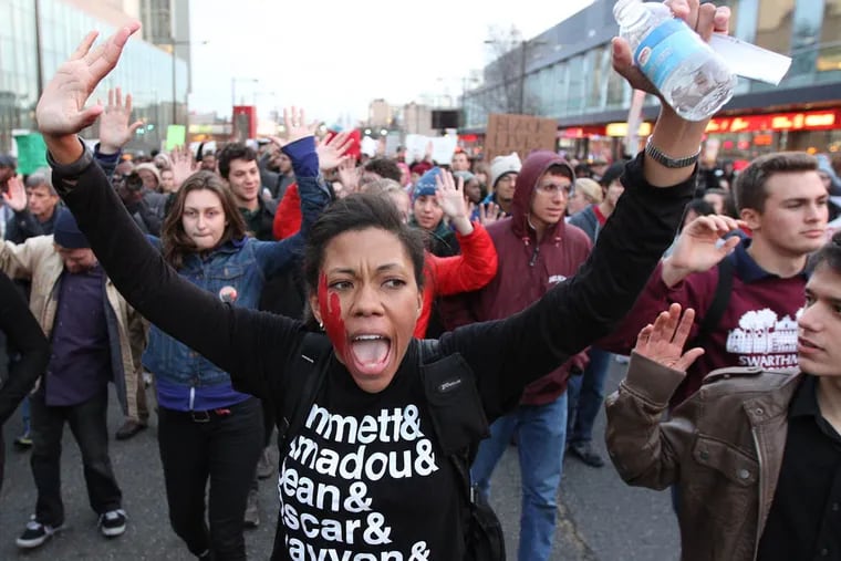 Loren Robbinson, of South Philly, joins a Ferguson protest at Broad and Cecil B. Moore in  Philadelphia on November 25, 2014. ( DAVID MAIALETTI / Staff Photographer )