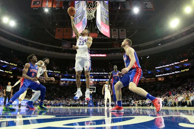 Trey Burke of the Sixers goes up for a shot against the Pistons during the first half.