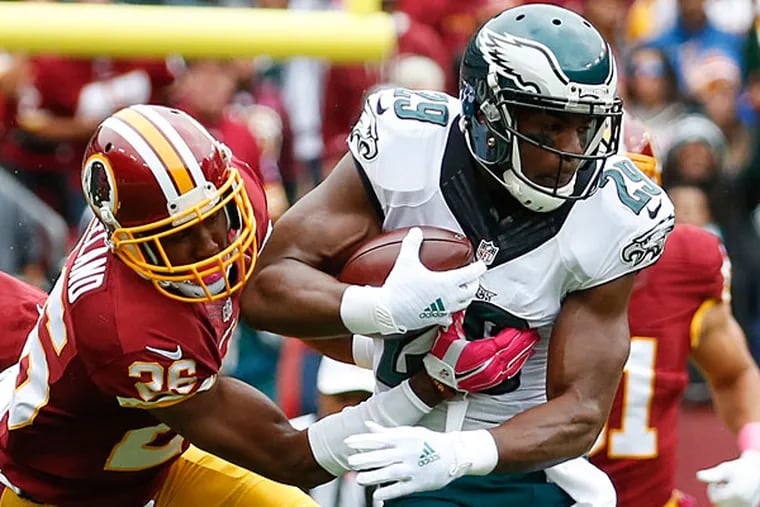 Philadelphia Eagles running back DeMarco Murray (29) is stopped by
Washington Redskins cornerback Bashaud Breeland (26) during the first
half of an NFL football game in Landover, Md., Sunday, Oct. 4, 2015.