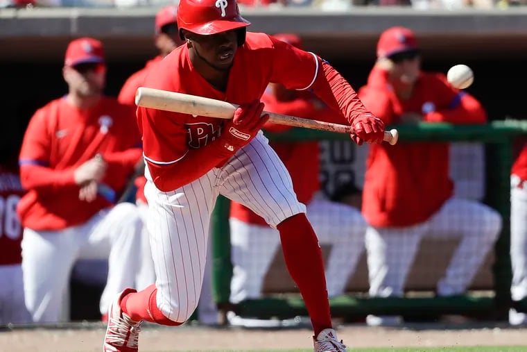 Phillies outfielder Roman Quinn prepares to bunt the baseball against the Baltimore Orioles in a spring training game at Spectrum Field in Clearwater, Fla.