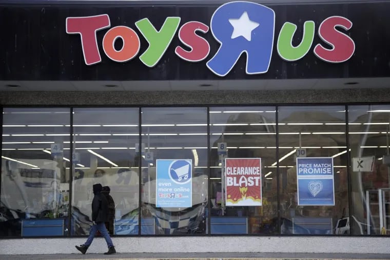 This Jan. 24, 2018, file photo shows a person walking near the entrance to a Toys R Us store, in Wayne, N.J.
