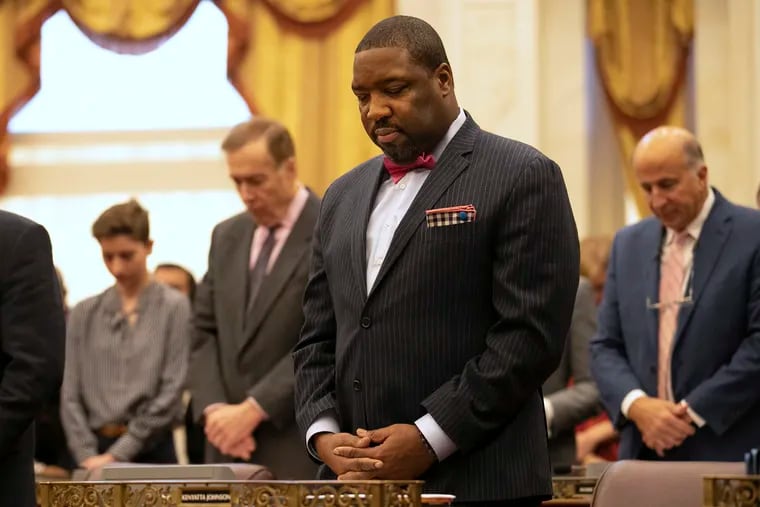 City Councilmember Kenyatta Johnson bows his head in prayer at his first Council meeting following his indictment on Thursday, Jan. 30, 2020. Johnson is being charged by the feds with using his office to enrich himself and his wife.