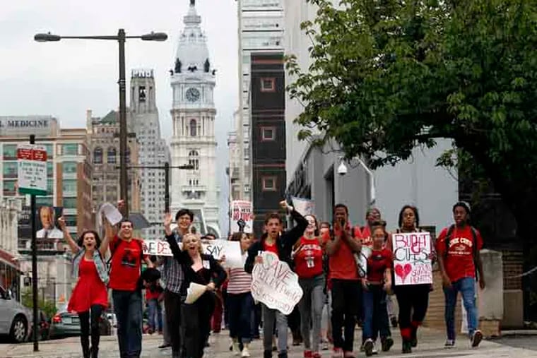 High School students march on the sidewalk towards the Philadelphia School District Headquarters on North Broad Street to protest budget cuts on Tuesday, May 7, 2013.  ( Yong Kim / Staff Photographer )