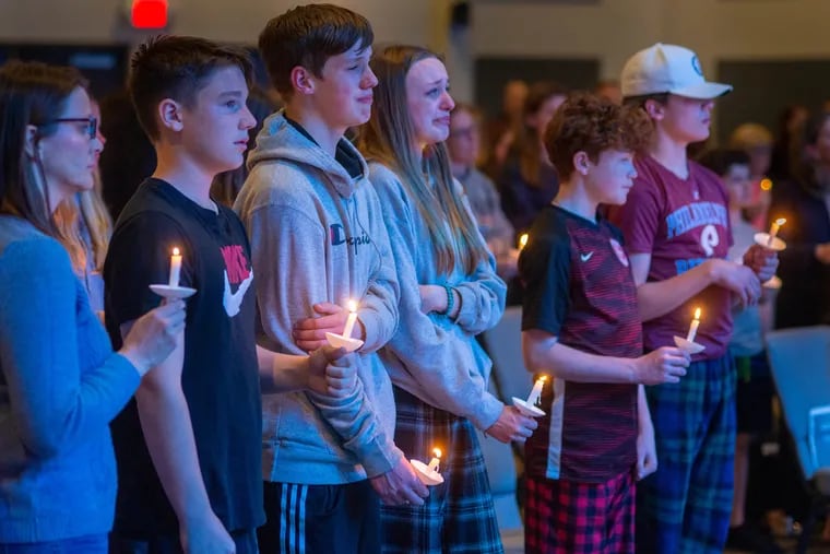 A group of children hold candles during a prayer vigil on Tuesday at Washington Crossing United Methodist Church in Washington Crossing, Pa. Investigators in Bucks County are trying to piece together the shooting of two children by their mother, Trinh Nguyen.