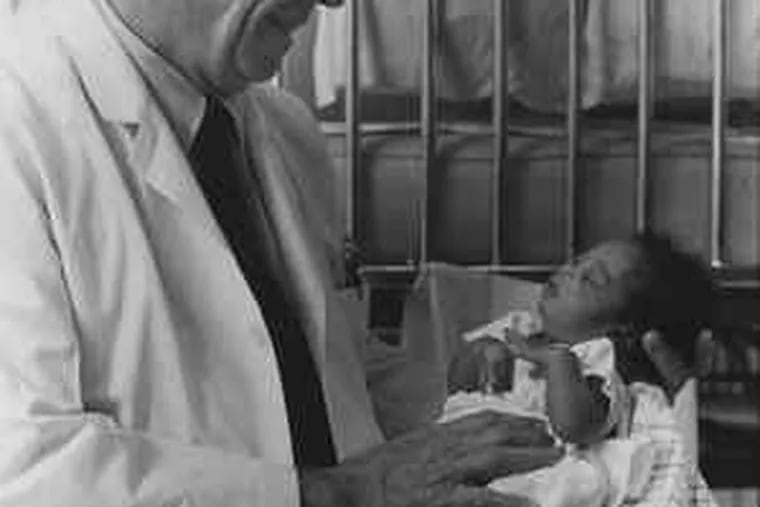 The doctor with a newborn. Said C. Everett Koop, his former partner: &quot;Philadelphia and the surgical world lost a warrior.&quot;