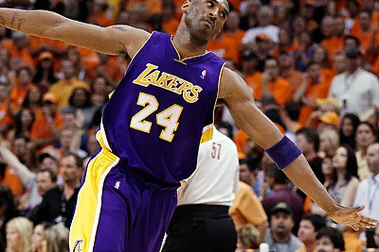 Los Angeles Lakers' Kobe Bryant makes his way down court after scoring against the Phoenix Suns. (AP Photo/Chris Carlson)