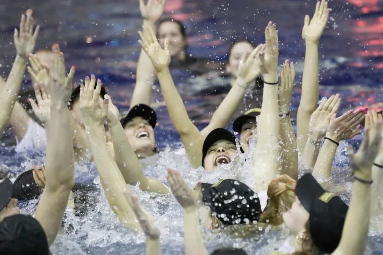 Virginia celebrates their championship win in the pool.
