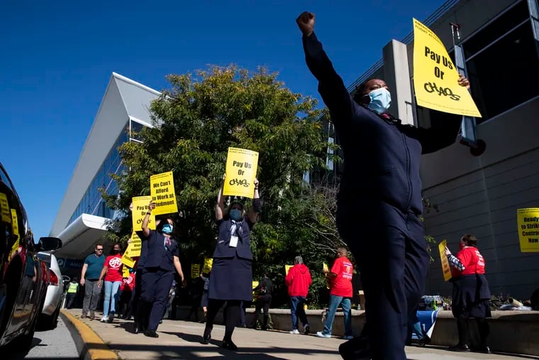 Union president for Piedmont flight attendants Keturah Johnson, on the right, picketed outside of Philadelphia International Airport on Oct. 21, 2021. On Wednesday, the flight attendants ratified a new contract with their employer that includes pay raises and a signing bonus.
