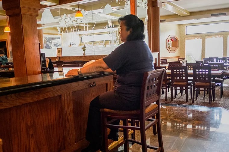 Yangming was acclaimed as one of the nation’s best. Customers complained and problems had not been corrected. Here, a worker sits in the shuttered restaurant. (ED HILLE/Staff Photographer)