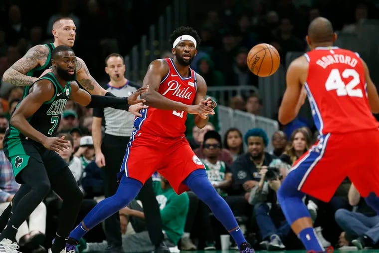 The Sixers' Joel Embiid,  passing to Al Horford as Boston's Jaylen Brown (7) and Daniel Theis double-team him, had a tough game against the Celtics.