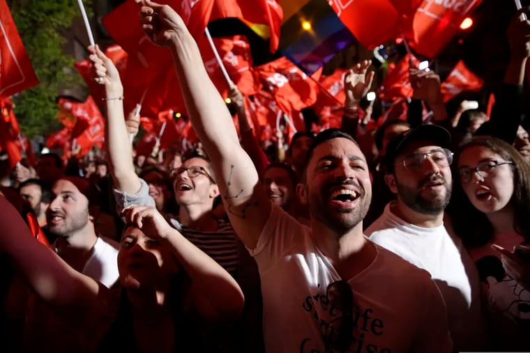 Supporters of Spanish Prime Minister and Socialist Party candidate Pedro Sanchez react as they gather at the party headquarters waiting for results of the general election in Madrid, Sunday, April 28, 2019. A divided Spain voted Sunday in its third general election in four years, with all eyes on whether a far-right party will enter Parliament for the first time in decades and potentially help unseat the Socialist government. (AP Photo/Andrea Comas)