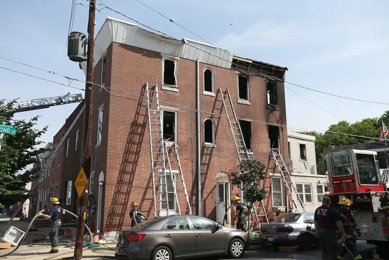 Firefighters cleanup after a fire at Almond Street and Lehigh Avenue in port Richmond on June 8, 2018. 