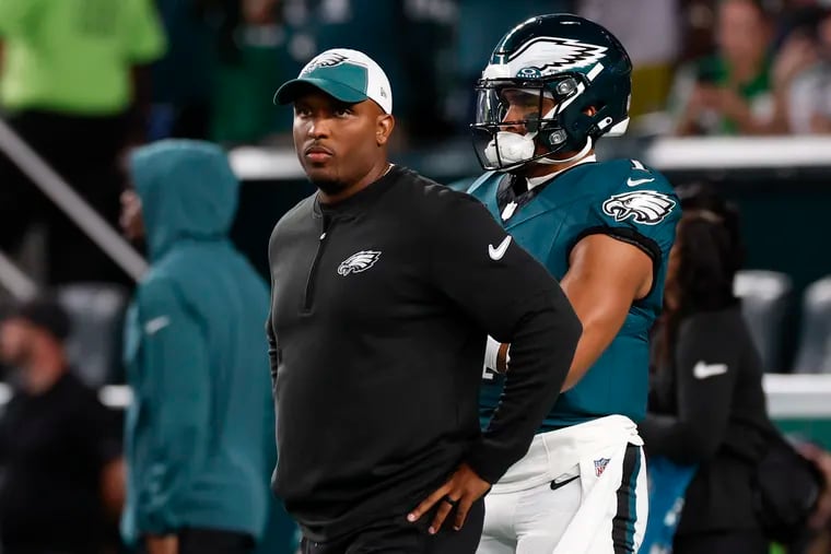 Eagles offensive coordinator Brian Johnson with quarterback Jalen Hurts before the victory over the Minnesota Vikings. Hurts failed to pass for 200 yards in each of the team's first two games.