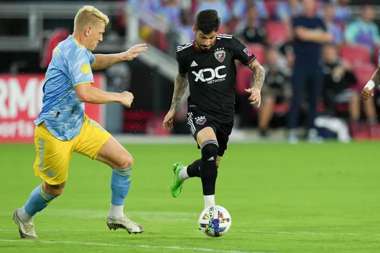 D.C. United forward Taxiarchis Fountas dribbles the ball while being defended by Philadelphia Union defender Jakob Glesnes.
